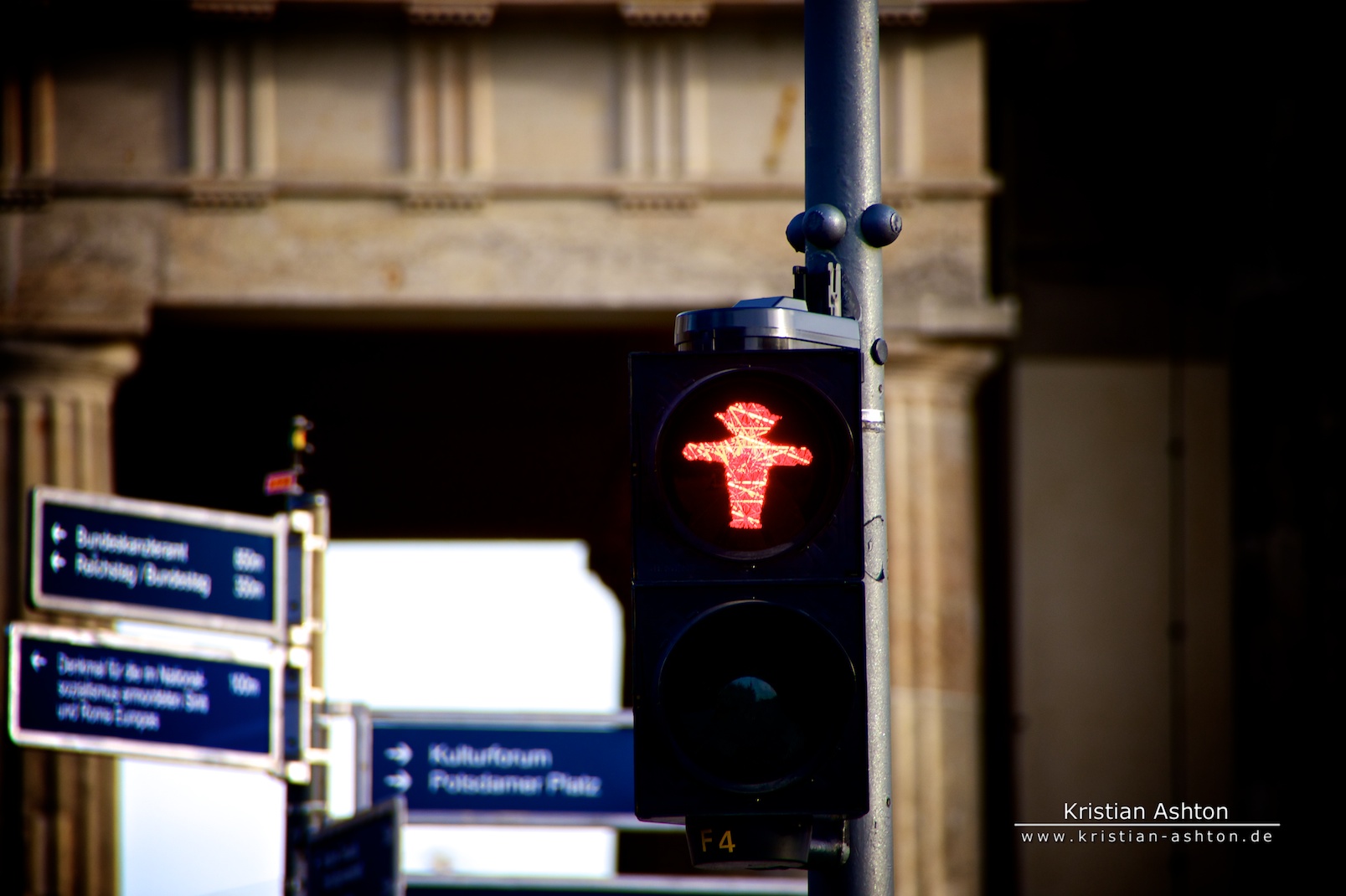 A red "Ampelmann" at the Brandenburg Gate